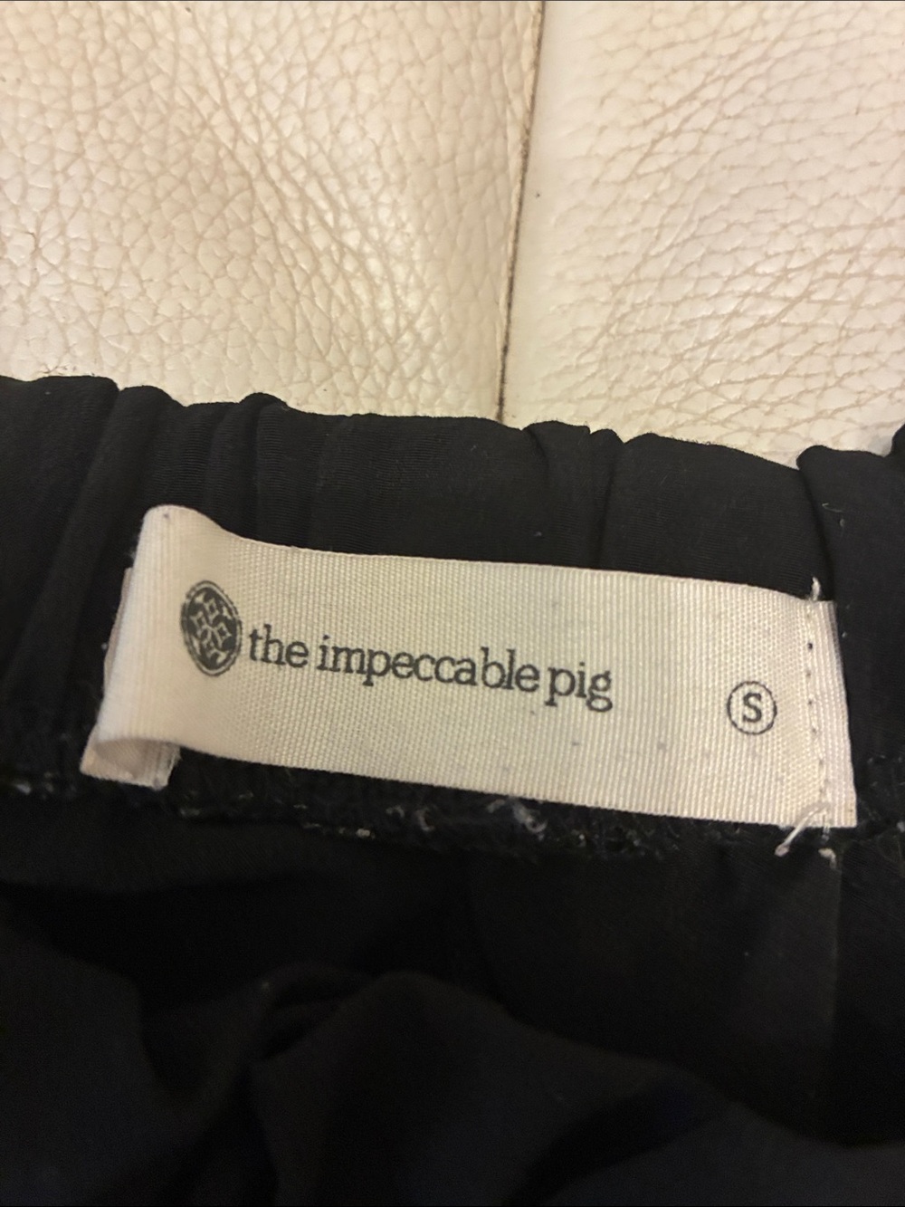 The Impeccable Pig Black Top with Logo Tag